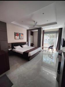 a bedroom with a large bed and a large window at Hotel Bhasmaarti Ujjain in Ujjain +14 photos