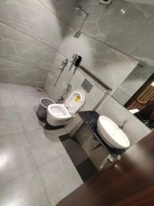 a bathroom with two toilets and a sink at Hotel Bhasmaarti Ujjain in Ujjain