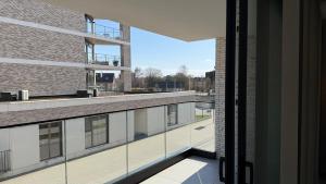 a view from the balcony of a building with glass windows at The 996 Business Flat in Lommel
