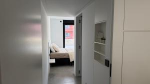 a bedroom with white walls and a bed in a room at The 996 Business Flat in Lommel