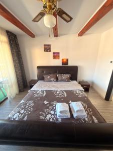 a bedroom with a large bed with two pillows at Casa David Turda in Turda