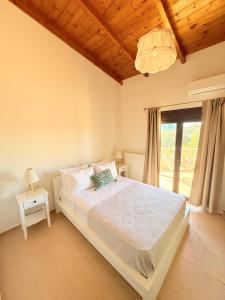 a bedroom with a large bed and a window at Villa Fanouris in Chania +42 photos