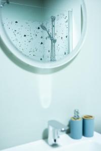 a mirror on a bathroom sink with birds flying around it at Apartament centru in Râmnicu Vâlcea