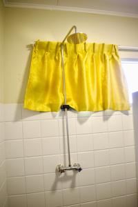 a yellow shower curtain in a bathroom next to a window at Nr 1 Spot in Paramaribo +46 photos