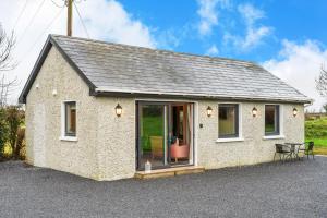 a small house with a window and a table at The Meadows at Marlhill in Tipperary