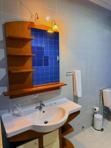 a bathroom with a sink and a mirror at MAG Palace Hotel in Bissau +66 photos