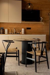 a kitchen with a table and two chairs and a television at Shepit space in Slavske +50 photos