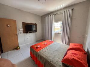 a bedroom with a bed and a tv and a window at Apartamento tecnoshow in Rio Verde +5 photos