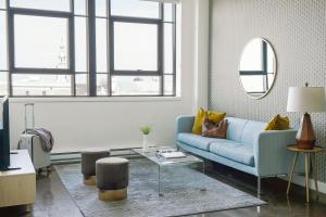 a living room with a blue couch and a table at The Cove Hotel - Plateau Mont-Royal in Montreal +31 photos