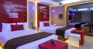 a hotel room with two beds and a living room at V Boutique Viaducto in Mexico City