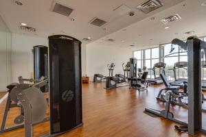 a gym with treadmills and machines in a room at Romantic Beachfront Sunsets in Panama City Beach