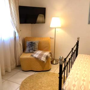 a living room with a chair and a lamp at Casa CedenoXavi in Santa Ponsa