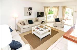 a living room with two couches and a coffee table at Casa CedenoXavi in Santa Ponsa