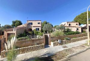 an old house in a village with a fence at Casa CedenoXavi in Santa Ponsa
