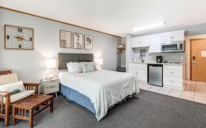 a large bedroom with a bed and a kitchen at Ground Floor River Front Studio Cottage in Bend