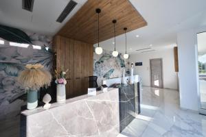 a lobby with a counter with vases and flowers on it at Le perle del golfo Scafati in Scafati