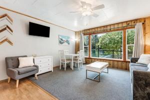 a living room with a couch and a table at Ground Floor Riverside Cottage with Patio in Bend