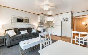 a living room with a couch and a kitchen at Ground Floor Riverside Cottage with Patio in Bend