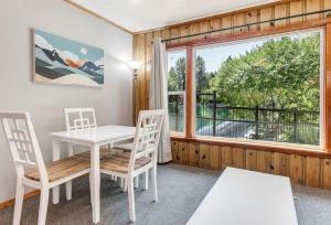 a dining room with a table and chairs and a window at Ground Floor Riverside Cottage with Patio in Bend +32 photos
