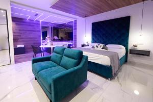 a bedroom with a bed and a blue couch at Le perle del golfo Scafati in Scafati +71 photos