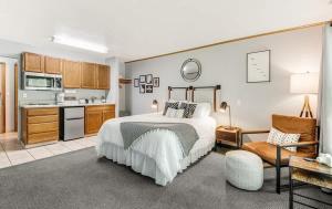 a large bedroom with a bed and a kitchen at Pet Friendly Riverside Studio in Downtown Bend in Bend