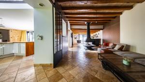 a living room with a couch and a table at Maison ALMA Piscine -Baby Foot - Cheminée- Jacuzzi in Vantoux