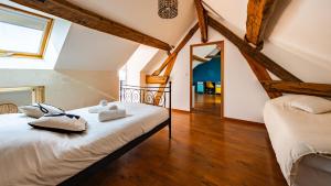a bedroom with a bed and a mirror at Maison ALMA Piscine -Baby Foot - Cheminée- Jacuzzi in Vantoux +51 photos