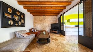 a living room with a couch and a table at Maison ALMA Piscine -Baby Foot - Cheminée- Jacuzzi in Vantoux