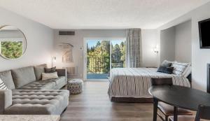a living room with a bed and a couch at Updated Condo with Deschutes River View in Bend