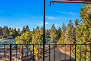 a view from a balcony with trees in the background at Updated Condo with Deschutes River View in Bend