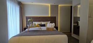 a bedroom with a large bed with a wooden headboard at HB Selection Hotel in Miraflores