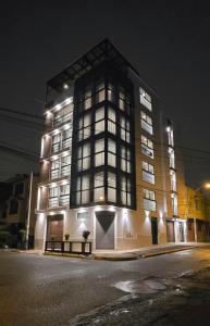 a large building with lights on it at night at HB Selection Hotel in Miraflores