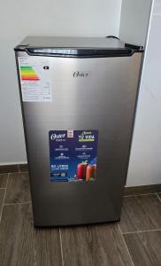 a refrigerator with a sticker on the front of it at HB Selection Hotel in Miraflores
