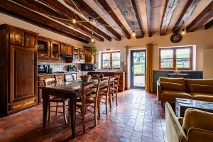 a kitchen with a table and chairs in a room at La Maison de Barbara in La Guiche