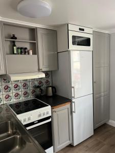 a kitchen with a white refrigerator and a stove at Rådstugugatan 32 in Nora