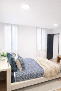 a bedroom with a bed with pillows on it at La Petite Escale Manosquine in Manosque