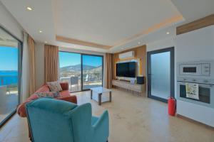 a living room with a couch and a tv at Villa Sheyma in Kalkan