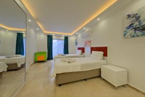 a bedroom with two beds and a glass wall at Villa Sheyma in Kalkan +35 photos