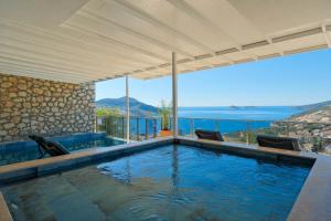 a swimming pool with a view of the ocean at Villa Sheyma in Kalkan