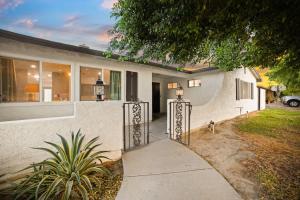 a house with a walkway leading to a driveway at Cozy Retreat with Pool, BBQ and Fire Pit in Indio