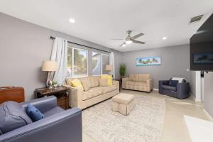 a living room with two couches and a tv at Cozy Retreat with Pool, BBQ and Fire Pit in Indio