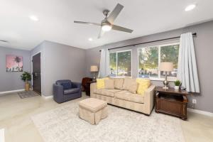 a living room with a couch and a table at Cozy Retreat with Pool, BBQ and Fire Pit in Indio +37 photos