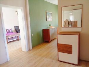 a room with a mirror and a dresser in it at Harmony Apartment in Strumica