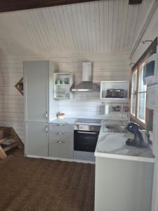 a kitchen with white cabinets and a stove at Casa Rural Las Bodegas in Setenil