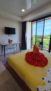 a bedroom with a bed with a red umbrella on it at PB325 Ideal studio apartment in Phuket in Ban Mai Salae