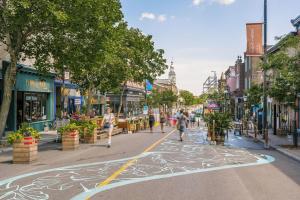 a city street with people walking down the street at The Cove Hotel - Plateau Mont-Royal in Montreal