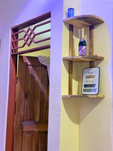 a shelf with a bottle on it next to a door at Ways Rest in Msaranga