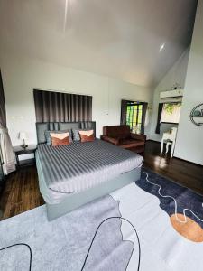 a bedroom with a large bed and a couch at เขากิวเทอเรส @สิชล in Sichon +38 photos