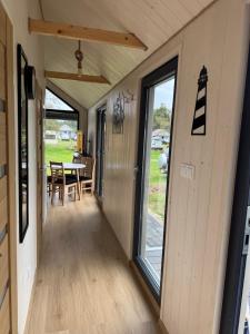 a hallway of a tiny house with a table and chairs at Sosnowe Zacisze in Dębki