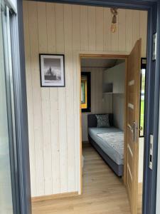 a tiny house with a door leading into a bedroom at Sosnowe Zacisze in Dębki